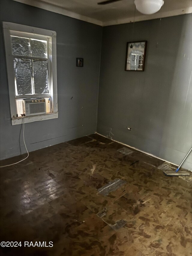 empty room featuring ceiling fan and cooling unit