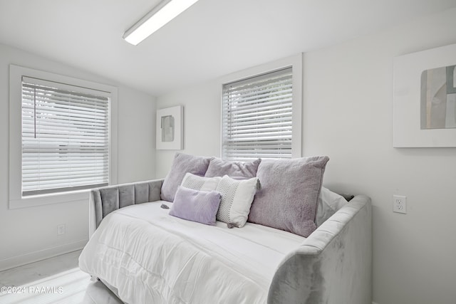 bedroom featuring vaulted ceiling and multiple windows