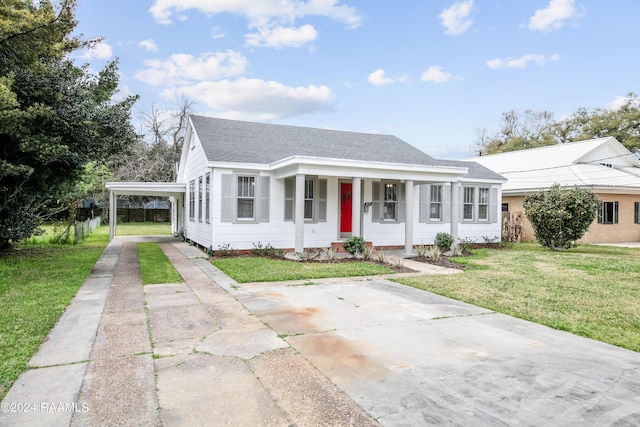 view of front facade with a carport, a porch, and a front yard