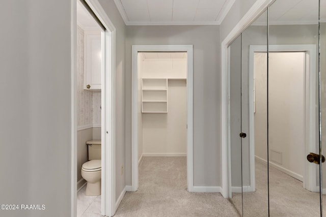 interior space with toilet and ornamental molding