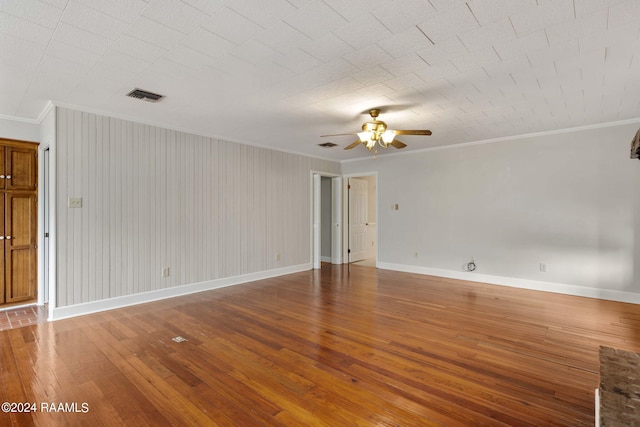 spare room featuring ceiling fan, wood-type flooring, and ornamental molding