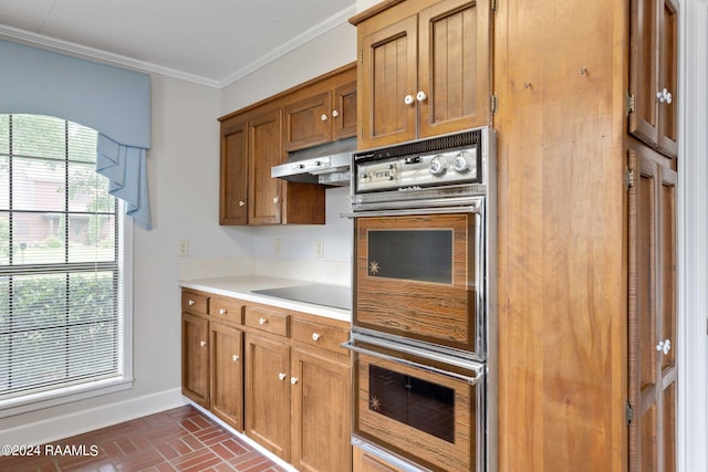 kitchen with black electric stovetop, ornamental molding, and double wall oven