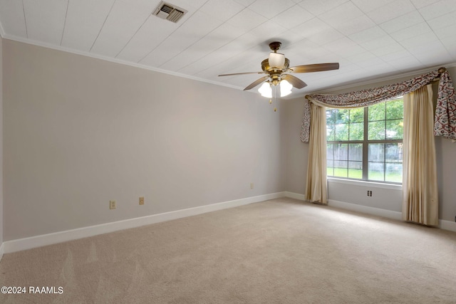 unfurnished room with light colored carpet, ceiling fan, and ornamental molding