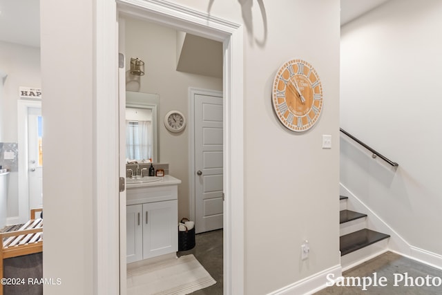 stairs featuring sink and carpet