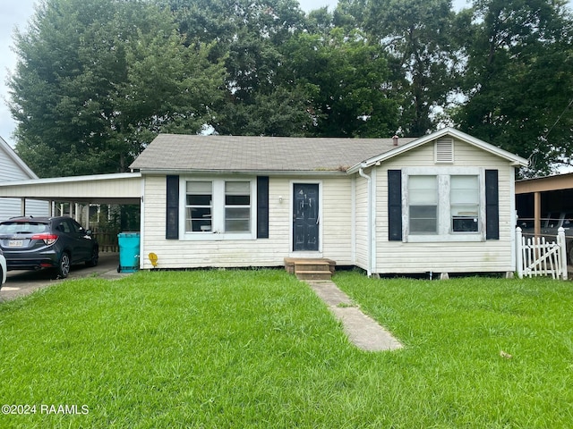 view of front facade featuring a front yard and a carport