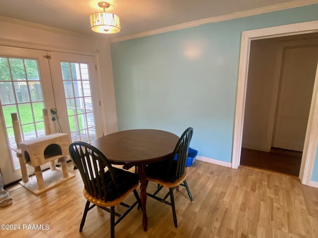 dining space featuring crown molding, french doors, and light hardwood / wood-style floors