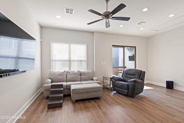 living room with hardwood / wood-style flooring, plenty of natural light, and ceiling fan