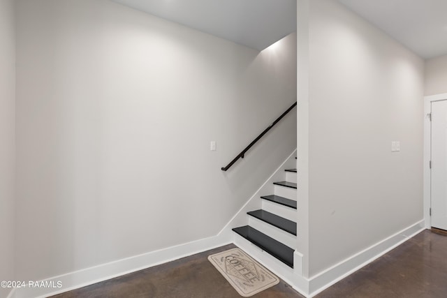 stairs featuring concrete floors