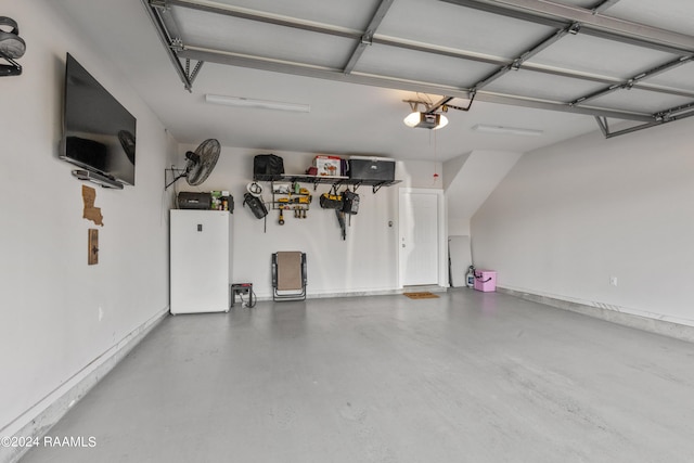 garage featuring a garage door opener and white refrigerator