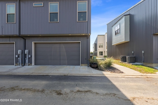 view of front facade with a garage and central air condition unit