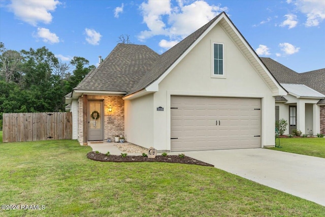 view of property featuring a front yard and a garage