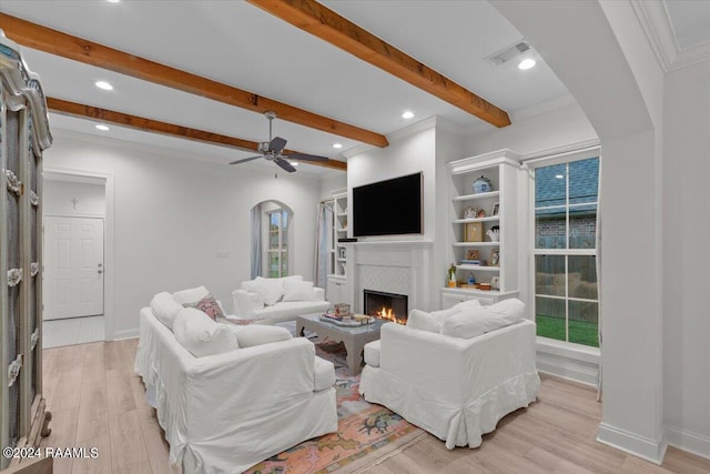 living room with light hardwood / wood-style floors, ceiling fan, and ornamental molding