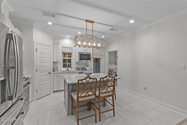 kitchen featuring backsplash, stainless steel appliances, white cabinets, a kitchen island, and hanging light fixtures