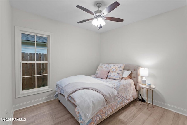 bedroom with light wood-type flooring and ceiling fan