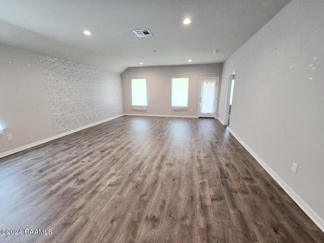 spare room featuring a textured ceiling and dark hardwood / wood-style flooring