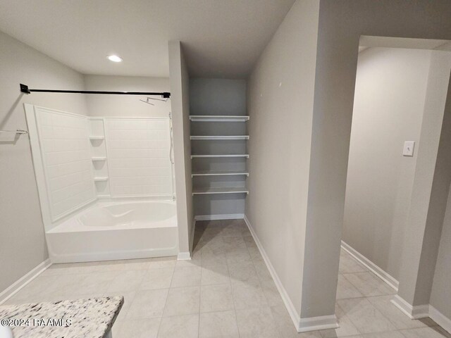 bathroom featuring tile flooring and shower / bathing tub combination