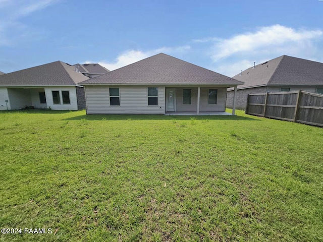 back of house featuring a yard