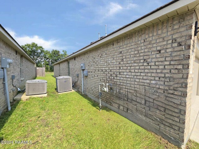 view of yard featuring central air condition unit