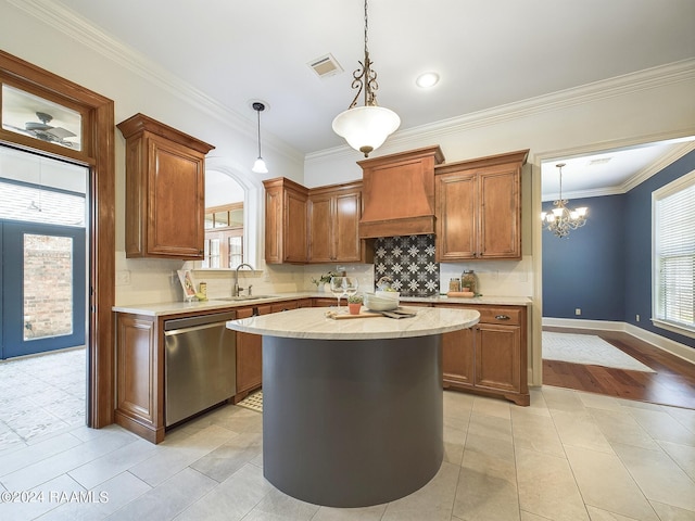 kitchen with sink, stainless steel dishwasher, hanging light fixtures, and wall chimney exhaust hood