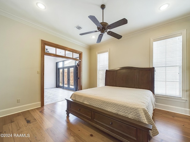 bedroom with hardwood / wood-style flooring, ceiling fan, crown molding, and access to outside