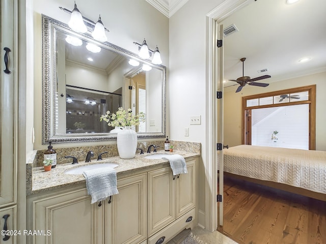 bathroom featuring ornamental molding, hardwood / wood-style floors, vanity, and walk in shower