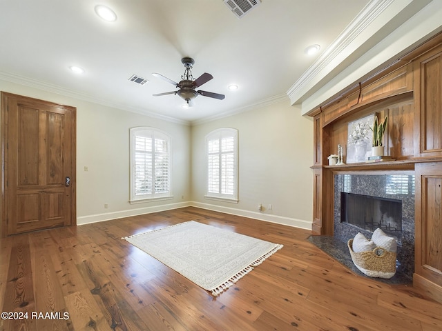 unfurnished living room featuring crown molding, a fireplace, and dark hardwood / wood-style floors