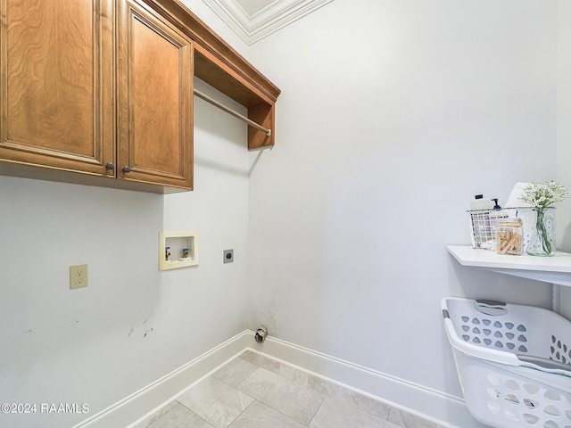 clothes washing area featuring crown molding, cabinets, hookup for a washing machine, and hookup for an electric dryer