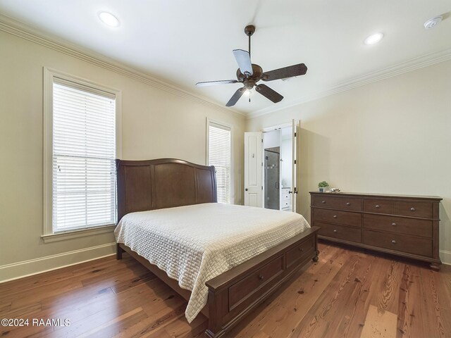 bedroom with ceiling fan, ornamental molding, and dark hardwood / wood-style flooring