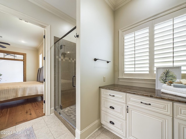 bathroom featuring tile patterned flooring, crown molding, and walk in shower