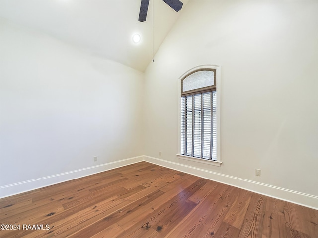 unfurnished room with ceiling fan, wood-type flooring, and high vaulted ceiling