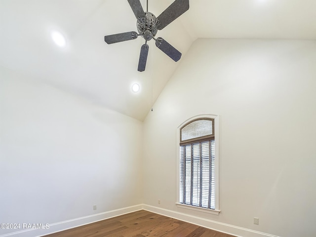 spare room with hardwood / wood-style floors, high vaulted ceiling, and ceiling fan