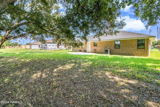 view of yard featuring central AC and a patio area