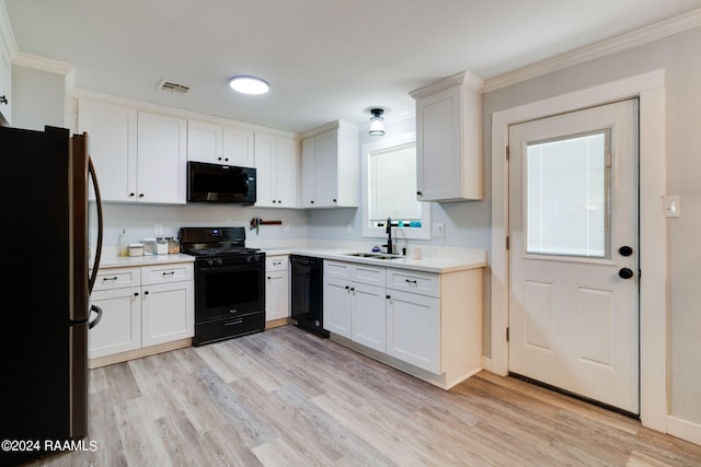 kitchen featuring white cabinets, light hardwood / wood-style floors, sink, and black appliances