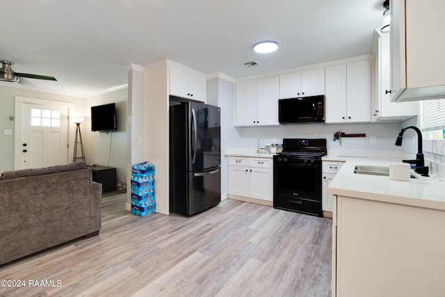 kitchen with white cabinetry, sink, light hardwood / wood-style flooring, and black appliances