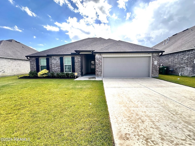 view of front of property featuring a garage and a front lawn