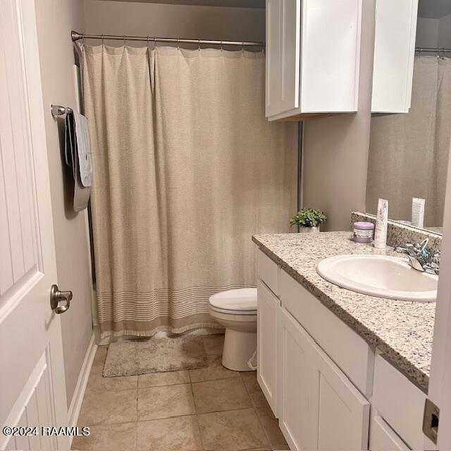 bathroom with tile patterned floors, vanity, and toilet