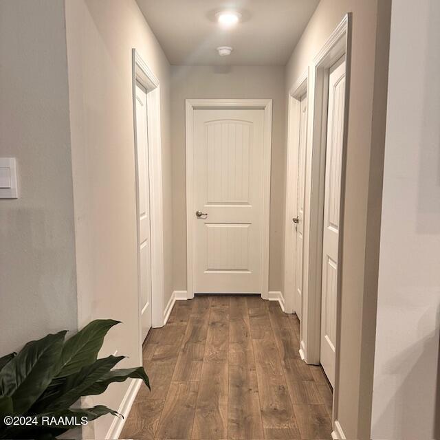 corridor with dark hardwood / wood-style floors