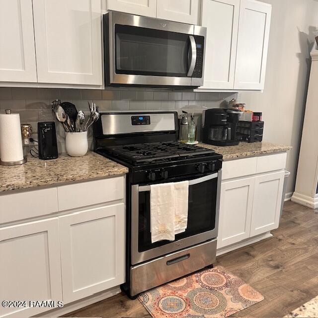 kitchen with white cabinets and appliances with stainless steel finishes