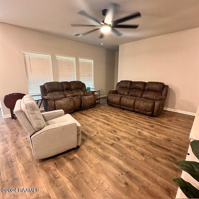 living room with ceiling fan and hardwood / wood-style floors