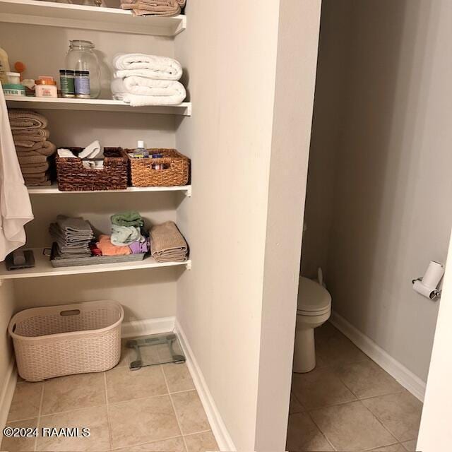 bathroom with tile patterned floors and toilet