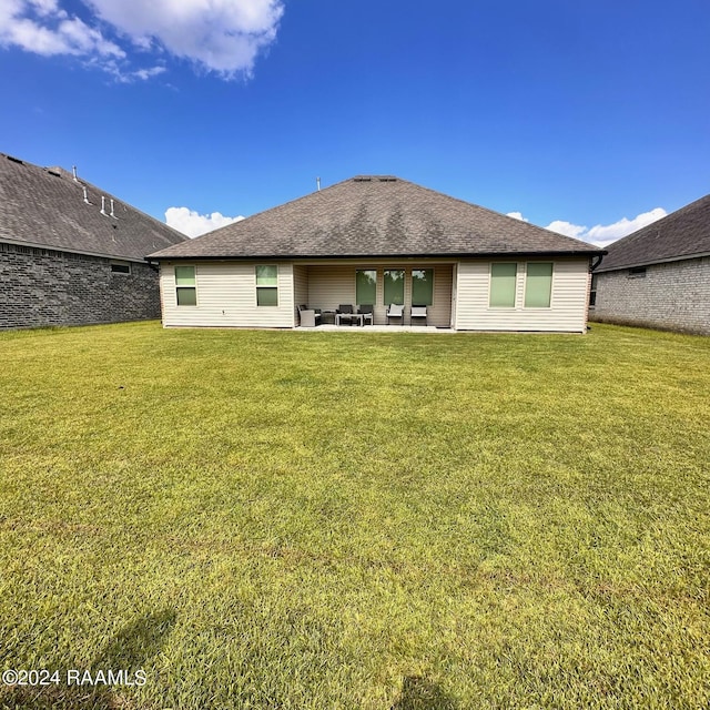 rear view of house featuring an outdoor hangout area, a yard, and a patio