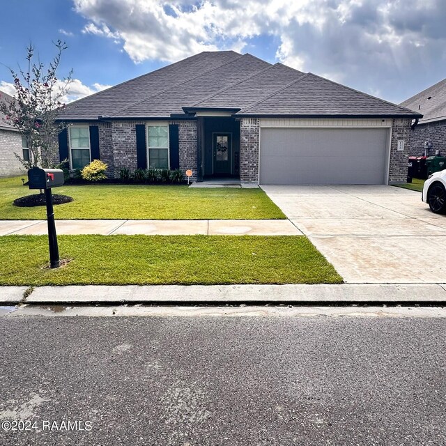 view of front facade with a garage and a front lawn