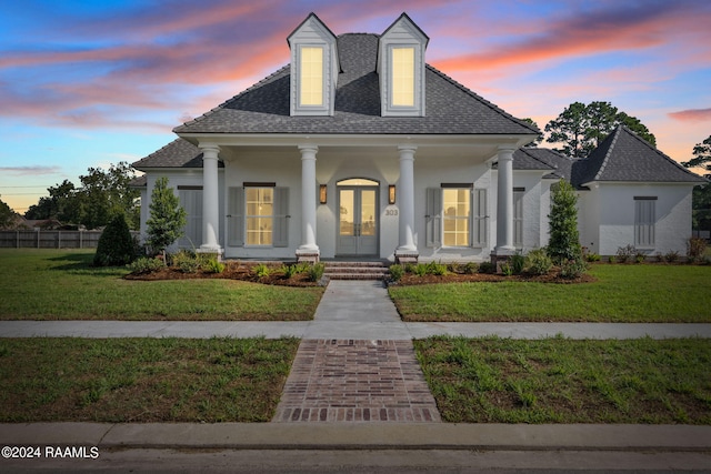 view of front facade featuring a porch and a yard