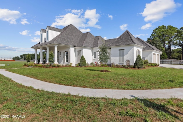 view of front of house featuring a garage, driveway, a front lawn, and stucco siding