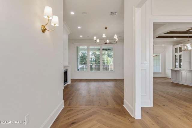 unfurnished living room with light wood-style flooring, beamed ceiling, a fireplace, a chandelier, and recessed lighting