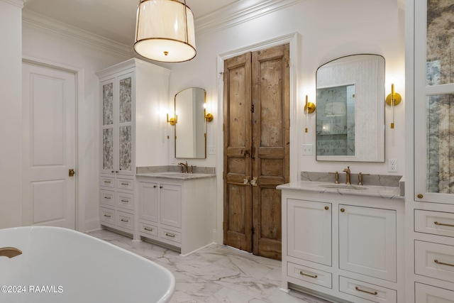 bathroom featuring vanity, crown molding, and a tub