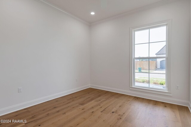 unfurnished room with light wood finished floors, baseboards, ornamental molding, and recessed lighting