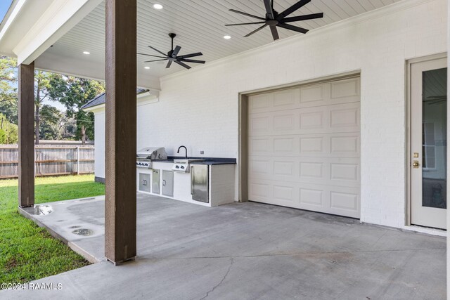 view of patio featuring ceiling fan, a garage, and grilling area