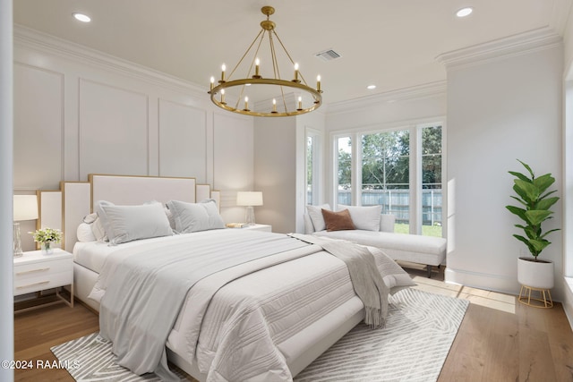 303 Ivy Cottage Dr, Youngsville, LA 70592 - bedroom featuring a chandelier, ornamental molding, wood finished floors, recessed lighting, and a decorative wall