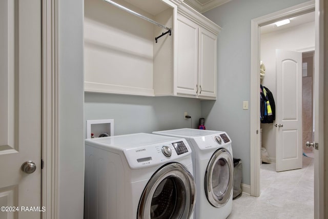 laundry area with cabinets, light tile patterned floors, independent washer and dryer, and crown molding